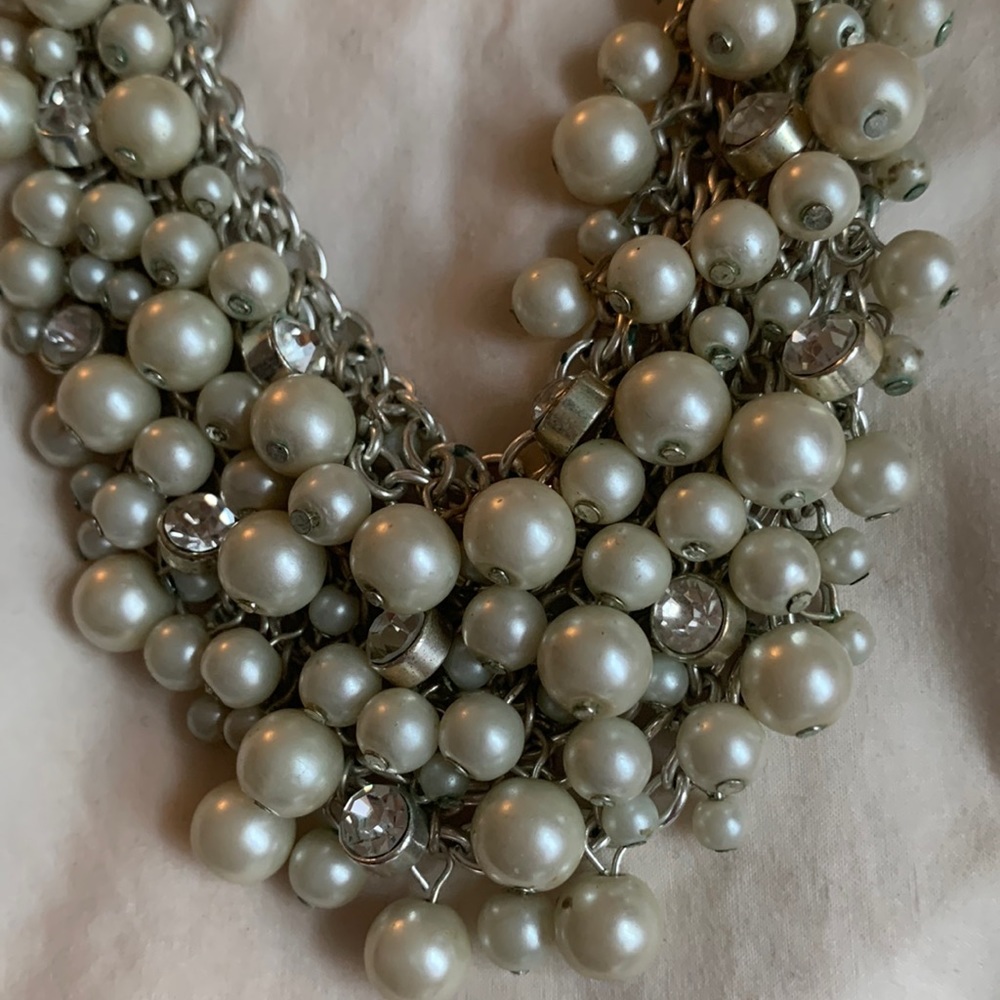 Cluster imitation pearl necklace with sparkly accents.